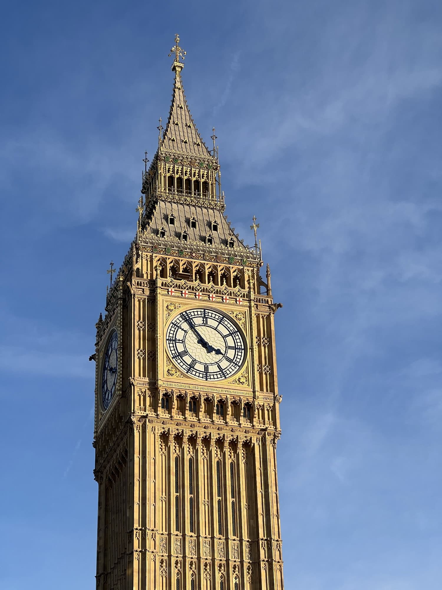 The clock tower known as Big Ben in London, showing the time at 2:40, with a clear blue sky in the background.